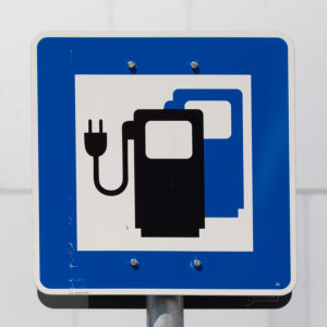 Ecology friendly electric car charging station road sign.