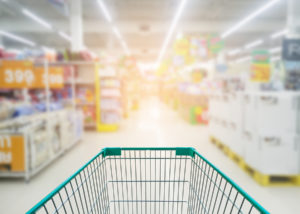 Supermarket store abstract blur background with shopping cart Supermarket aisle with empty shopping cart