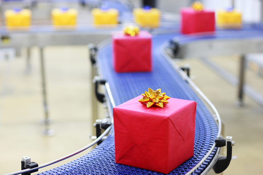 Gifts on conveyor belt in Christmas presents factory