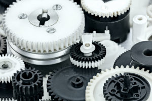 Parts Of Industrial Mechanisms. Plastic Black And White Cogwheel